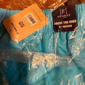 Men above the knee swimming trunks by George. 6” inseam. Neon blue color. New.